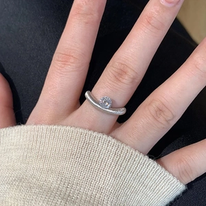 Minimalist silver ring with round zircon stone in curved vintage design on hand