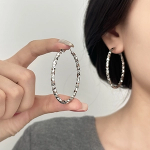 Silver textured hoop earrings with a large geometric hammered design for women