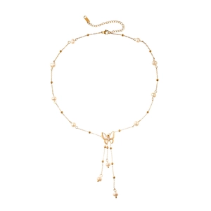 Golden butterfly necklace with freshwater pearls and tassels on a clean white background