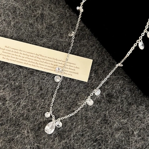 Elegant silver necklace with teardrop zircon pendants on a vintage poetic background