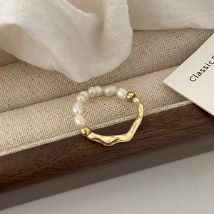 Elegant French style pearl ring with irregular gold wave band on linen jewelry tray