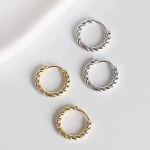 Minimalist twisted hoop earrings in gold and silver finish with elegant braided texture