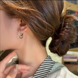 Double-layered silver hoops with micro-set zircons shown on model for elegant look