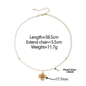 Detailed view of pearl necklace with a 17.7mm golden four-petal flower pendant