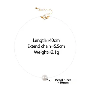 Macro detail of 10mm pearl necklace with transparent fishing line and gold clasp