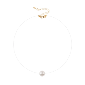 Close-up of minimalist single white pearl necklace with transparent line and gold clasp