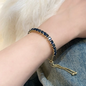 Elegant gold bracelet with square blue zircons and adjustable drawstring closure
