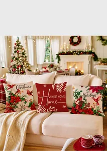 Macro view of textured linen Christmas pillow covers with festive floral and bird prints