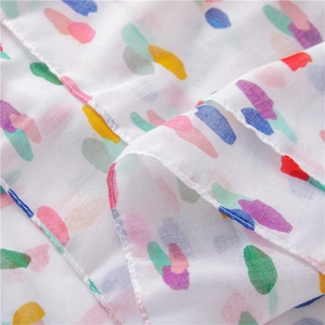 Macro detail of breathable cotton linen scarf fabric with vibrant colorful polka dots