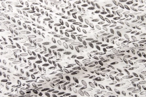 Macro detail of breathable cotton linen fabric with grey leaf print and smooth texture