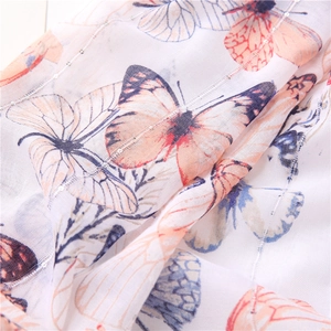 Detail of white cotton scarf with butterfly print and subtle sequin vertical stripes