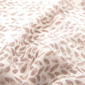 Detailed macro shot of cotton linen scarf featuring a subtle pearlescent leaf pattern