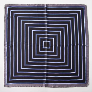 Détail d'un foulard carré en soie géométrique avec finition satinée et lignes épurées