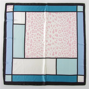 Detail of geometric scarf with leopard print center and modern color block pattern