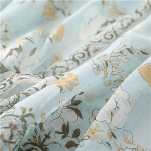Close-up of lightweight blue cotton linen scarf featuring delicate floral print details