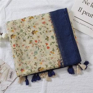 Detail of floral cotton linen scarf with contrast stitching and navy blue tassels