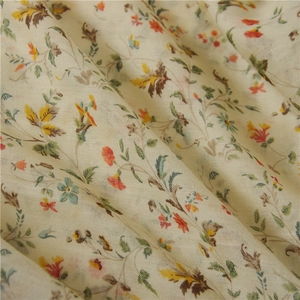 Detail of soft cotton linen fabric featuring a vintage floral pattern and delicate texture