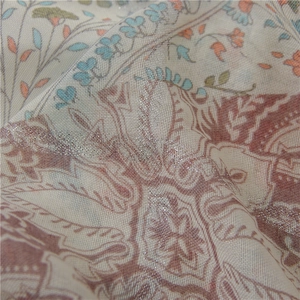 Detailaufnahme von lila Paisleymuster-Schal mit Silberfolie und metallischen Fäden