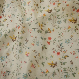 Macro shot of cotton linen scarf fabric with delicate floral patterns in blue and yellow