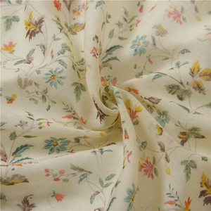 Close-up of floral print cotton linen fabric with soft texture and vibrant patterns