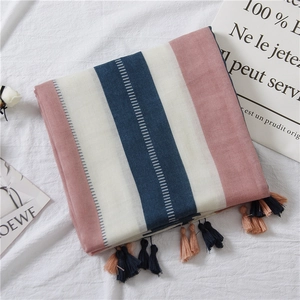 Close-up of pink and navy vertical stripe linen scarf with delicate fringe tassels