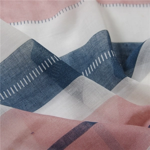 Close-up of light pink and blue striped linen scarf with fine woven texture detail