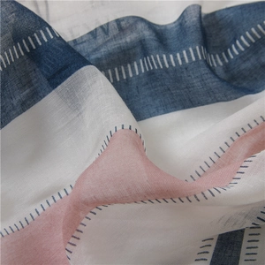 Detail of blue and pink patchwork linen scarf with white stitching and light texture