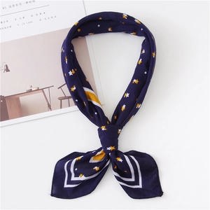 Navy blue square scarf with yellow star pattern and white stripes, knotted style