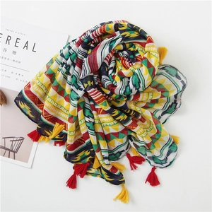 Detail of colorful geometric cotton linen beach scarf with vibrant tassel fringe edges