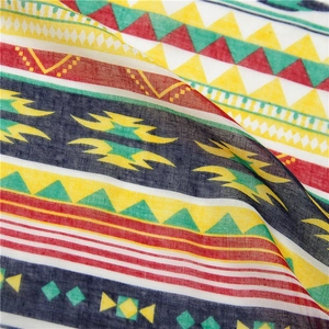 Detail of colorful geometric diamond pattern on breathable cotton linen summer beach shawl