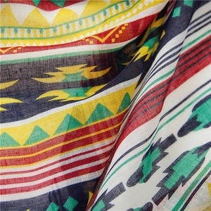 Macro detail of geometric print fabric with vibrant tribal patterns on a cotton-linen scarf