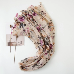 Detailed close-up of floral print cotton linen scarf with elegant tassel edge detail