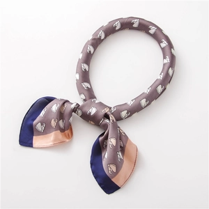 Detail of silk scarf with horse head print and elegant navy blue border stitching