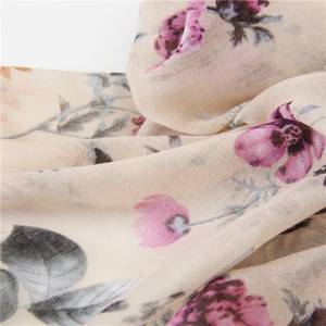 Close-up of pink floral print on lightweight breathable cotton linen scarf with tassels