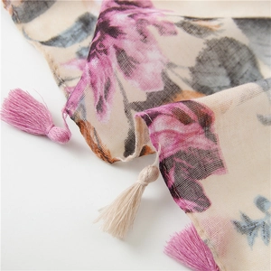 Close-up of floral print cotton scarf showing texture and pink tassel details