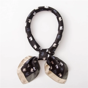 Detailed close-up of horse print satin scarf with contrasting patchwork borders