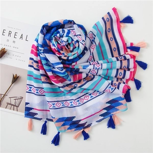 Detail shot of bohemian striped cotton linen scarf with colorful tassels and geometric patterns