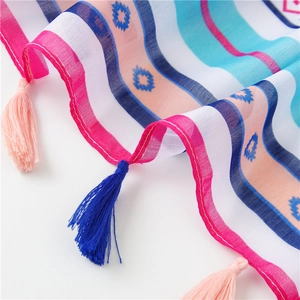 Close-up of colorful striped cotton linen scarf with geometric floral patterns and tassels