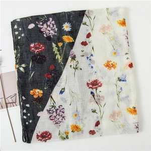 Detail of floral linen scarf with contrast black and white design and colorful wildflowers