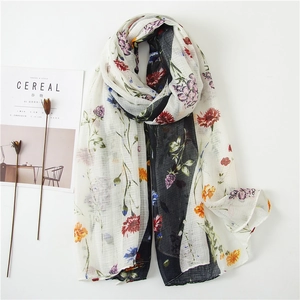 Cotton linen floral scarf with tassels and colorful flower prints on white background