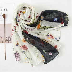 Floral print cotton linen scarf with tassels and stripes on a minimalist white background