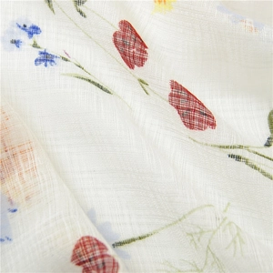 Detailed macro view of lightweight cotton linen scarf with floral print and fringe details