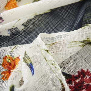Detailed macro view of cotton linen scarf with floral print and breathable mesh texture