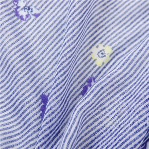 Detail of blue and white striped cotton-linen scarf with delicate purple floral print