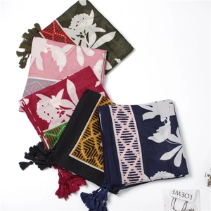 Detail of floral printed scarves in various colors with handmade tassel edge decorations