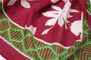 Detail shot of wine red cotton linen scarf with white floral patterns and green borders
