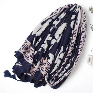 Detailed macro view of navy blue and pink floral scarf with elegant fringe tassels
