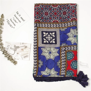 Detail shot of bohemian ethnic print scarf with navy tassels and intricate geometric patterns