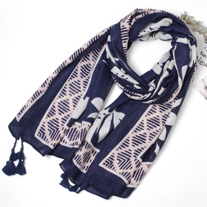 Detail of navy and pink leaf print scarf with fringe tassels on white background