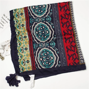 Detail shot of bohemian square shawl with tassels and multi-color ethnic prints